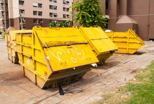 Skip truck delivering waste container to a construction site in Newham