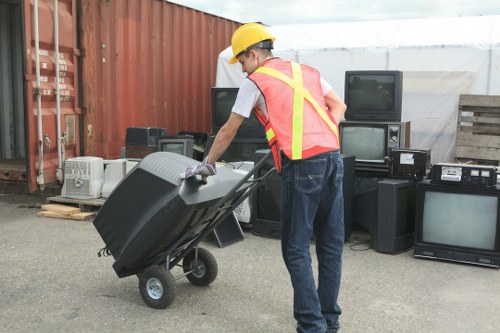 Workers recycling materials from a skip